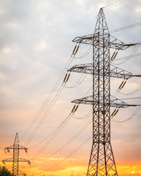 high-voltage-power-transmission-towers-with-electrical-energy-wires-sunset